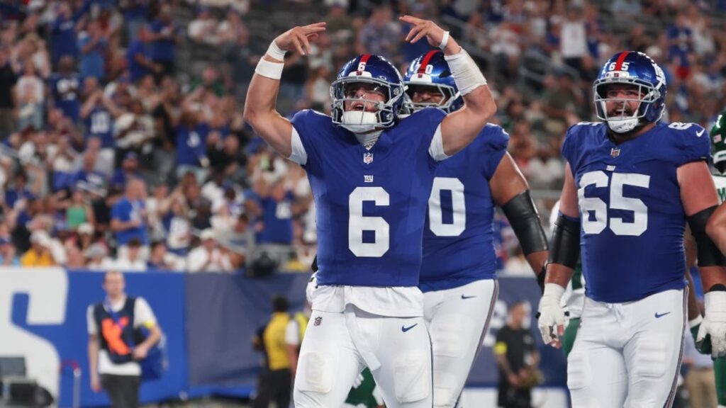 Jaxson_Dart_celebrating_touchdown_hands_up_Giants_blue_jersey_preseason_game_2025.jpg